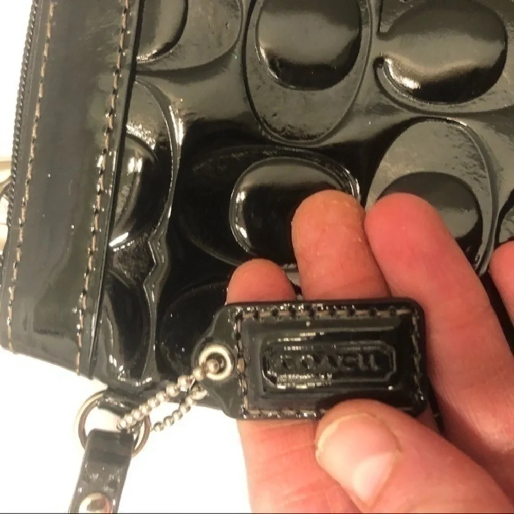 Coach embossed black leather wristlet clutch bag